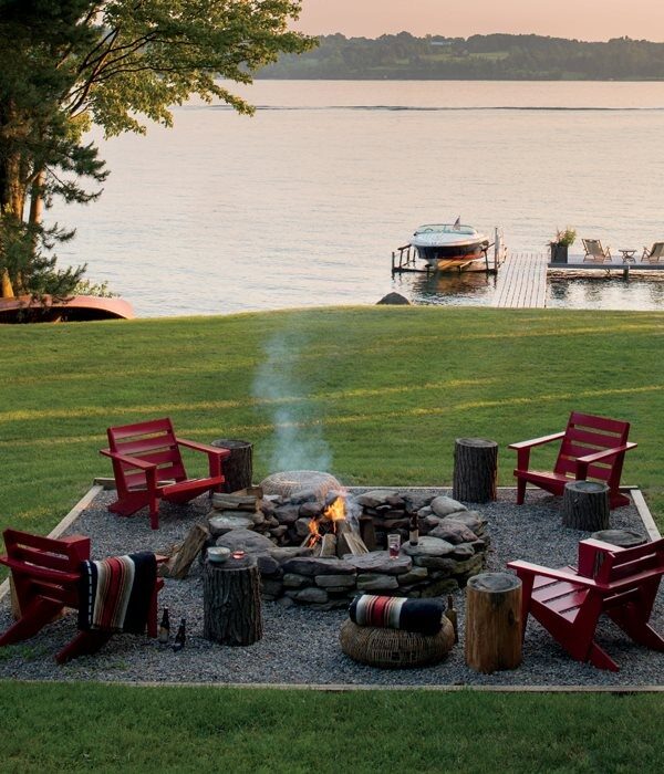 backyard fire pit. gravel around and framed with adirondak chairs