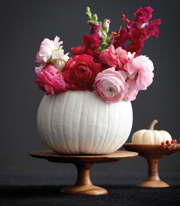 A simple centerpiece: Painted white pumpkin filled with flowers