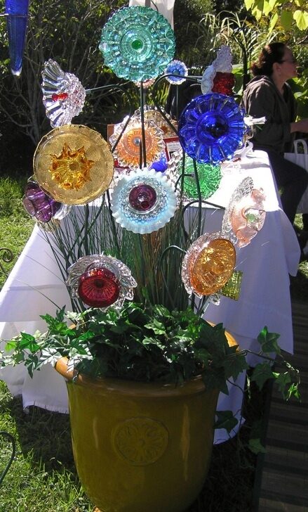 Thrift store glass plates into garden flowers.