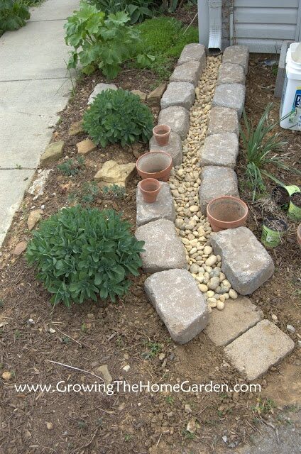 Making A Dry Creek Bed Drainage Canal for Downspouts. One of the most creative ideas I’ve seen for this project.