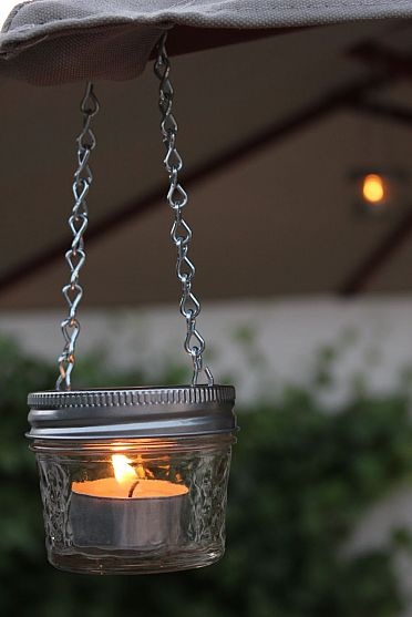 Hang mini mason jar candles to light up your great outdoors.