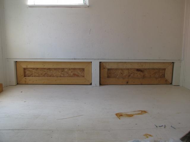 Genius! Inside view of a flip door that allows the owners to push all dirty litter straight out, to make for easy cleaning. A couple of well-placed wheelbarrows would make coop cleaning a breeze!