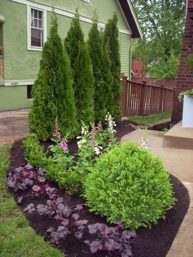 Layering evergreens and flowering shrubs will create visual interest year-round and provide a level of privacy in your yard.