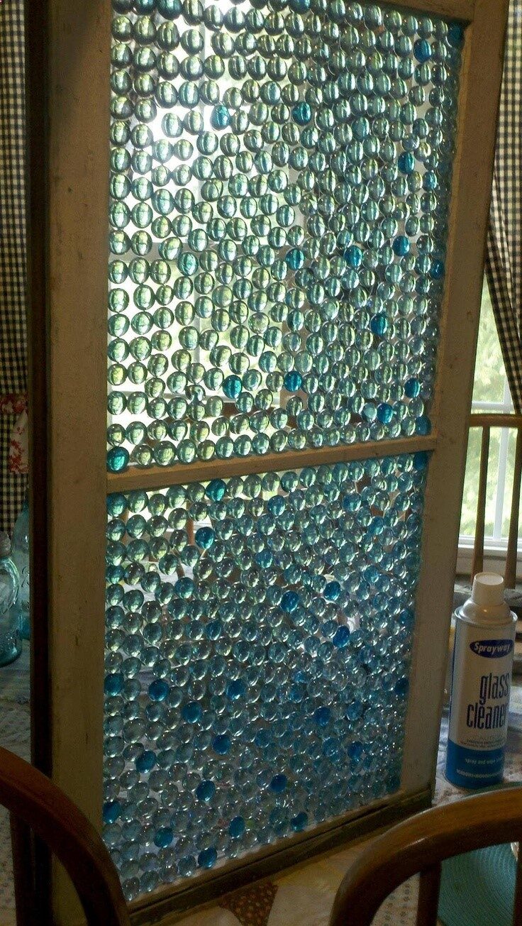 Glass Pebbles from the Dollar Store create this stain glass window look. This would be fabulous in the garden with the sun beaming through.