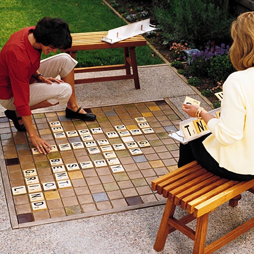 DIY Backyard Scrabble: The 5 foot square board doubles as a poured concrete patio floor. The letter tiles were made from adhesive backed vinyl letters stuck onto squares of baseboard trim and then sealed with spray lacquer!
