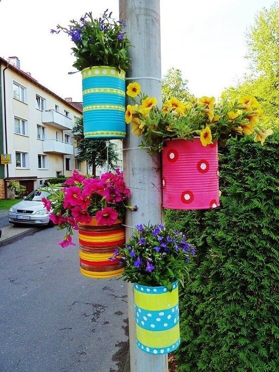 Coffee cans tied to a pole! just punch two holes in back of can and run a wire thru to tie to a pole ot tree!