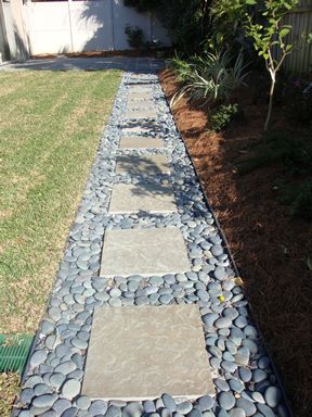 rock and paver walkway- maybe with pea gravel for a walkway to the hose?