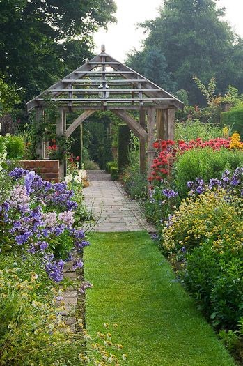 Pretty cottage garden with rustic pergola