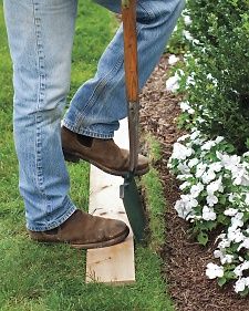 A humble plank of wood in any size provides a terrific alternative to the string-and-spade method of edging a lawn.