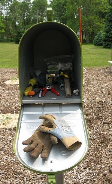 Mailbox in the garden to hold gloves and tools. Keeps things dry and clean and right where you need them. Could make this really cute too!