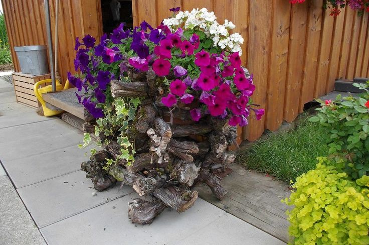 Stacked branches to hide a plastic container, love it!
