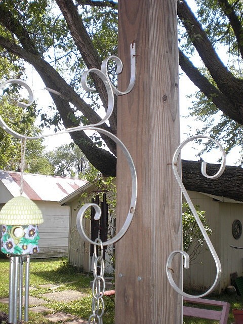 Upcycled screen door grill as yard art