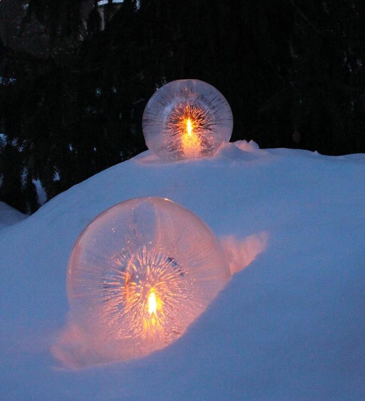 Fill a round balloon with water and set outside on top of a tea light until frozen. This will leave a tealight shape at the bottom of the sphere. Tear off the balloon and insert battery tea light into the space. So different, so amazing!