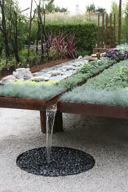 Raised beds, collecting rainwater as well. – perhaps tiered beds can have a French drain at the end that catches excess water run off from the rain. It would be a larger area to collect rain water and would only be extra If the other plants were all watered.