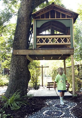 50 Kids Treehouse Designs…low tree house with tent frame and small front ladder.
