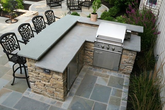 outdoor grill and bar design plans | Outdoor fieldstone kitchen featuring raised stone bar counter, grill …
