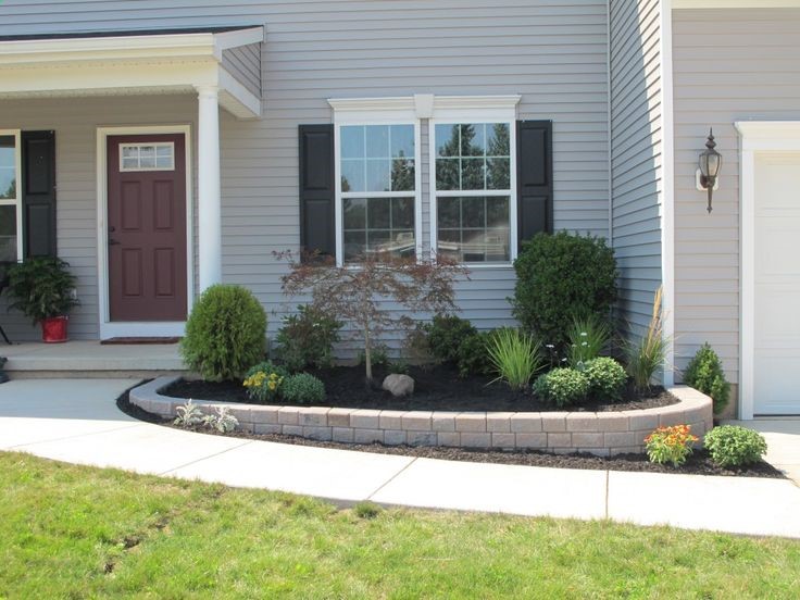 Could build up our one side that goes downhill so that its even with the other side (like in this picture). Low Maintenance Front Yard Landscaping | Front Yard Landscaping WNY | Serene Gardens