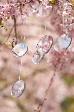 Fairy Lights. Six strands of double sided mirrors, four 11/2 inches in diameter and two 2 inches in diameter, are attached on varying lengths of monofilament line. Hang at uneven lengths over tree branches. The mirrors gently blow in the breeze, reflecting light when the sunlight catches them
