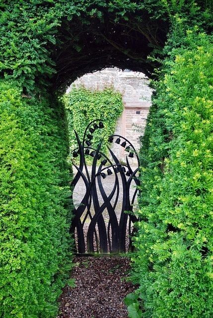 I MUST have pinned this before. I love the whimsical shape of the entry and OF COURSE, I love the gate. Lovely little pops of fragrant posies that lily of the valley are.