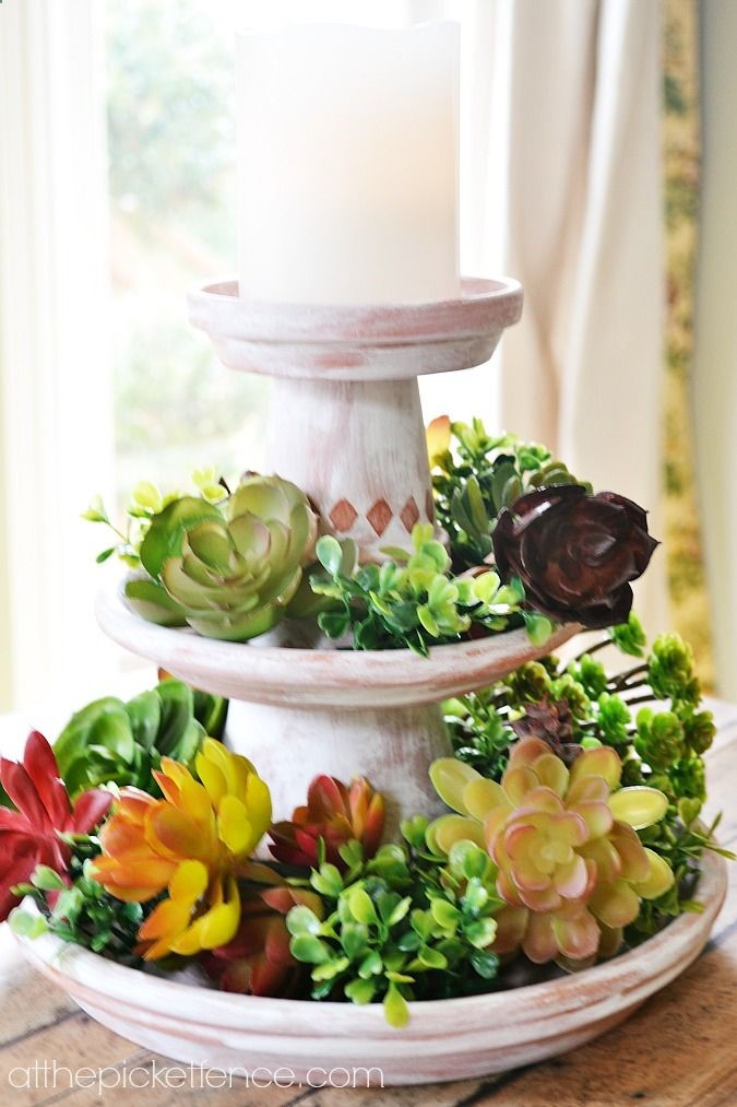 So simple and elegant! This tiered clay pot centerpiece looks so pretty with faux succulents but would be easy to switch out seasonally.