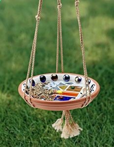 Decorative bird feeder – clay flower pot base tray suspended with macrame hangar (this one is simple, but easy enough to DIY, but would add beads or fancier knots)