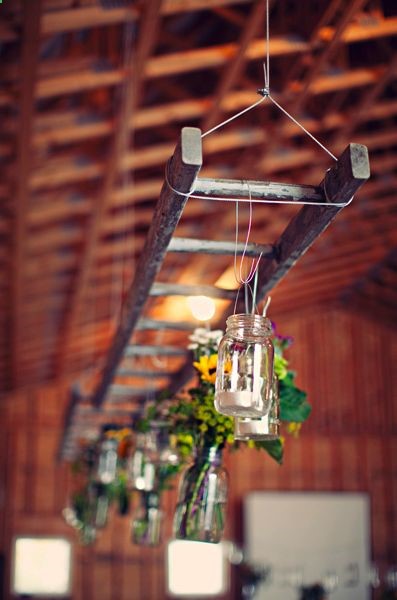 Hanging ladder with mason jar lights at this rustic wedding.