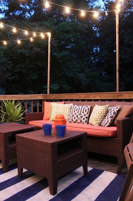outdoor rug for the deck, with comfortable seating, plants, and lights strung for lights… doesnt have to be a lot. just simple touches