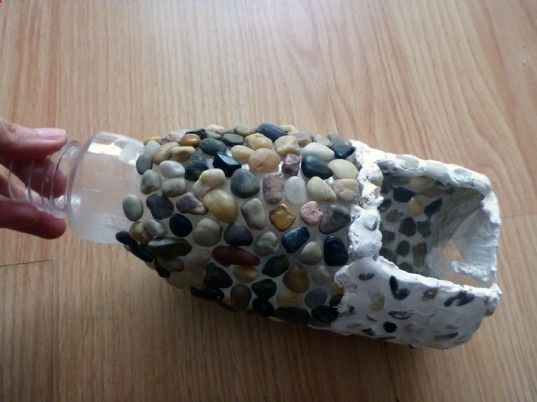 Start attaching-pebbles use hot glue,but if little hands are sticking them down, you can also use a super-strong double-sided tape, such as the type used to lay carpets. Its entirely up to you how closely youd like to pack those pebbles, as the grouting youll use to finish the effect will fill in any gaps.