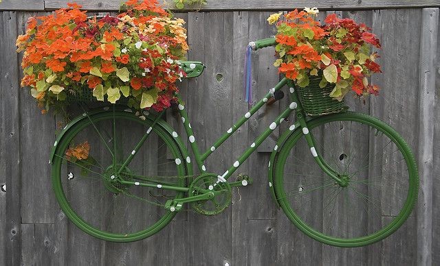 get creative… want a garden bike but dont have the room… hang it on the fence and add florals. What a great idea!