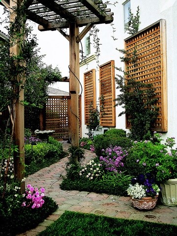 Tall Pergola When building a pergola, consider how the width, height, and depth will work in your overall landscape. This tall pergola in a narrow side yard is in perfect scale with the home and adds an impressive shady resting spot along the path.