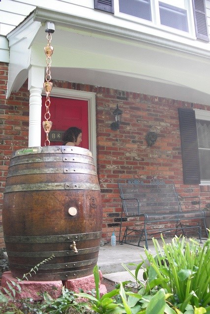Rain chain into decorative rain barrel with antique finish…blends nicely with house and colors.